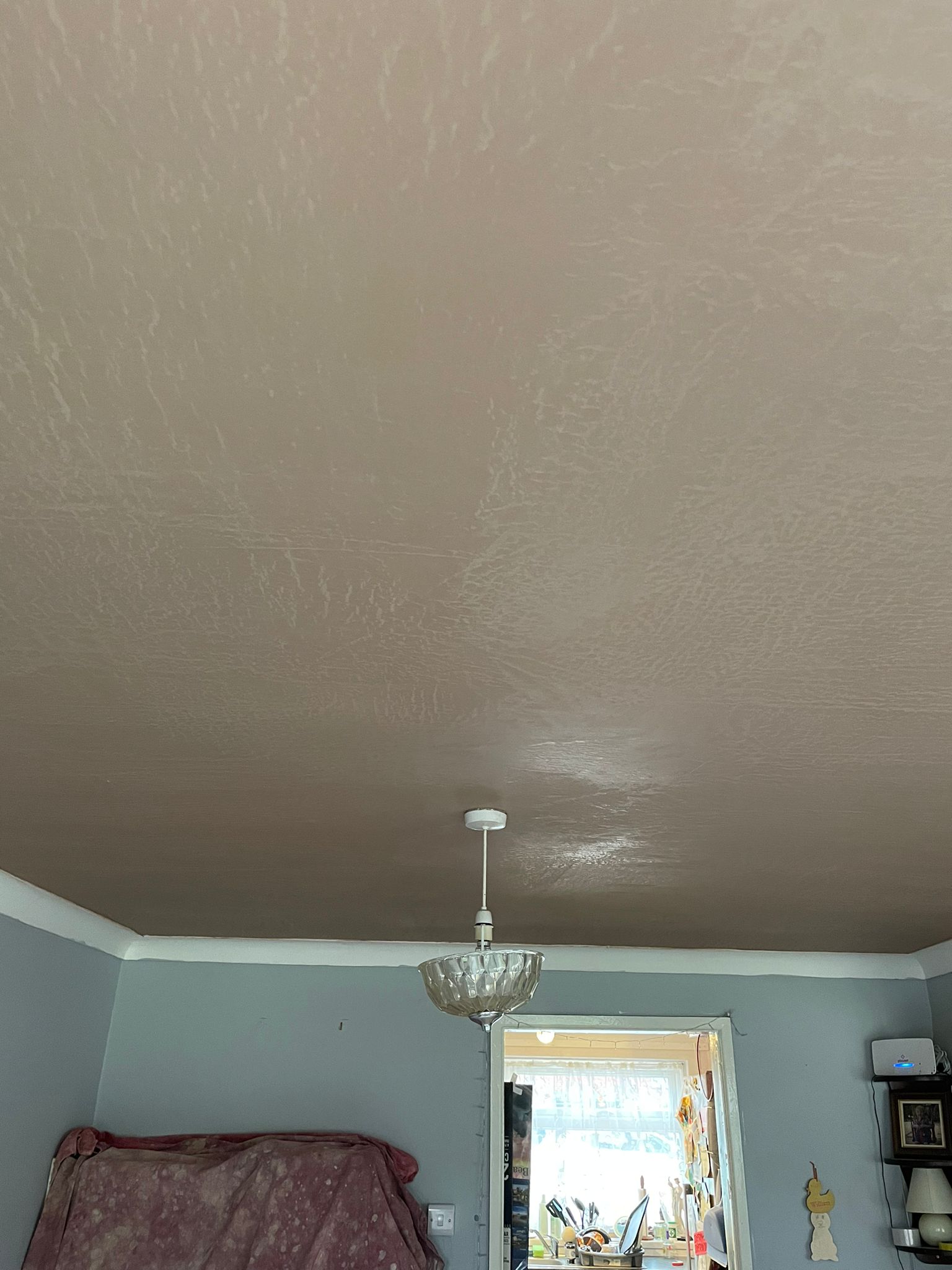 A smooth, freshly plastered ceiling with a pendant light, finished by Tenbury Plastering