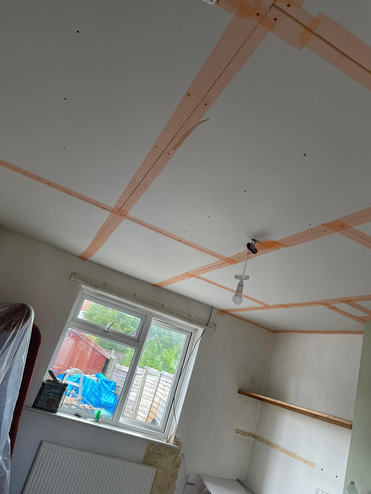 A ceiling boarded and taped before plastering